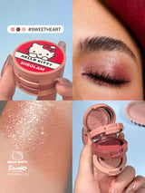 Sheglam Hello Kitty makeup product with close-up of application on eyelid and glittery texture.