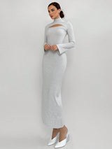 Woman wearing a gray long-sleeve dress with cut-out design on a white background