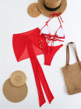 Red bikini set with white top, straw hat, and bag on a white background