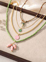 Necklaces with various charms on a neutral background