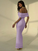 Woman wearing a purple off-shoulder dress against a neutral background