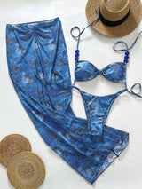 Blue tie-dye swimsuit with a hat and sandals on a white background