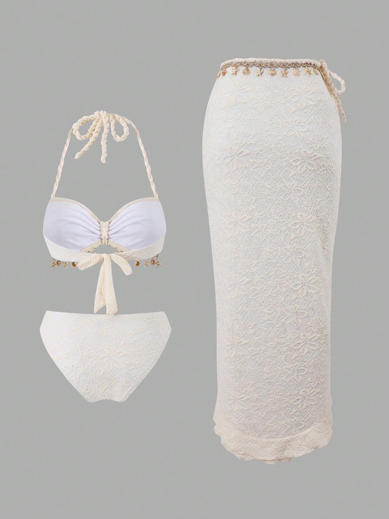 White lace bikini set with matching skirt on a gray background