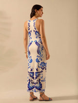 Woman wearing a sleeveless dress with blue floral patterns on a beige background