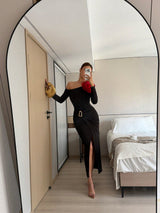 Person taking a mirror selfie in a modern bedroom