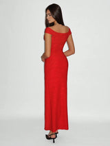 Woman wearing a red off-shoulder evening gown on a white background