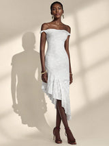Woman wearing a white off-shoulder dress against a neutral background