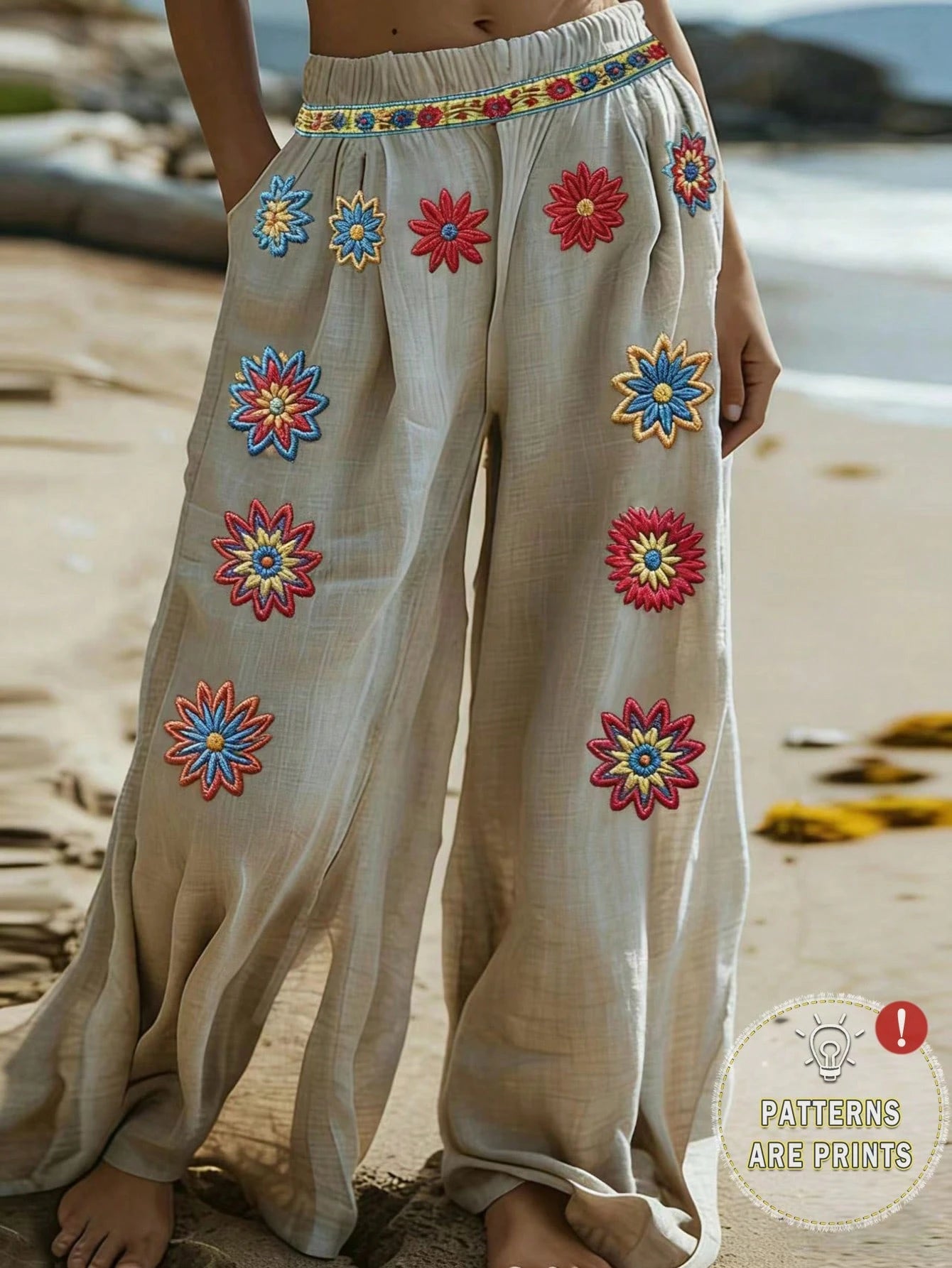 Beige pants with colorful floral patterns on a beach