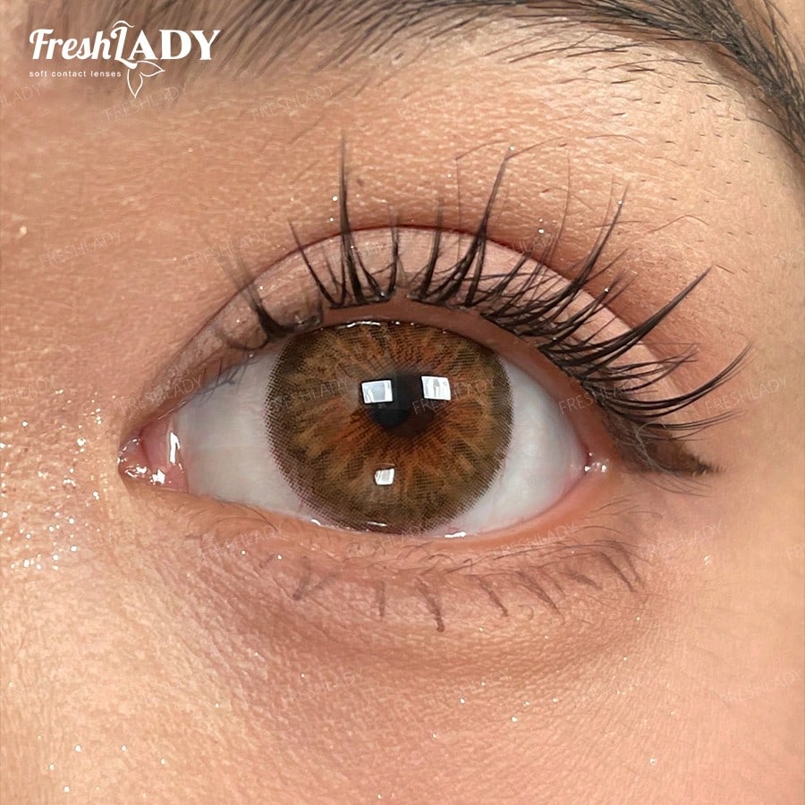 Close-up of a brown eye with long lashes, featuring the FreshLADY logo.