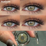 Four-panel close-up of a person's eye wearing long black false eyelashes, with a third panel showing a hand holding a clear contact lens bottle containing a green-gray iris design. The FreshLADY brand name appears in the top left and faintly as watermarks.
