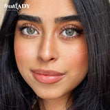Close-up of a woman's face showcasing false eyelashes, with the FreshLADY brand logo visible in the top left corner.