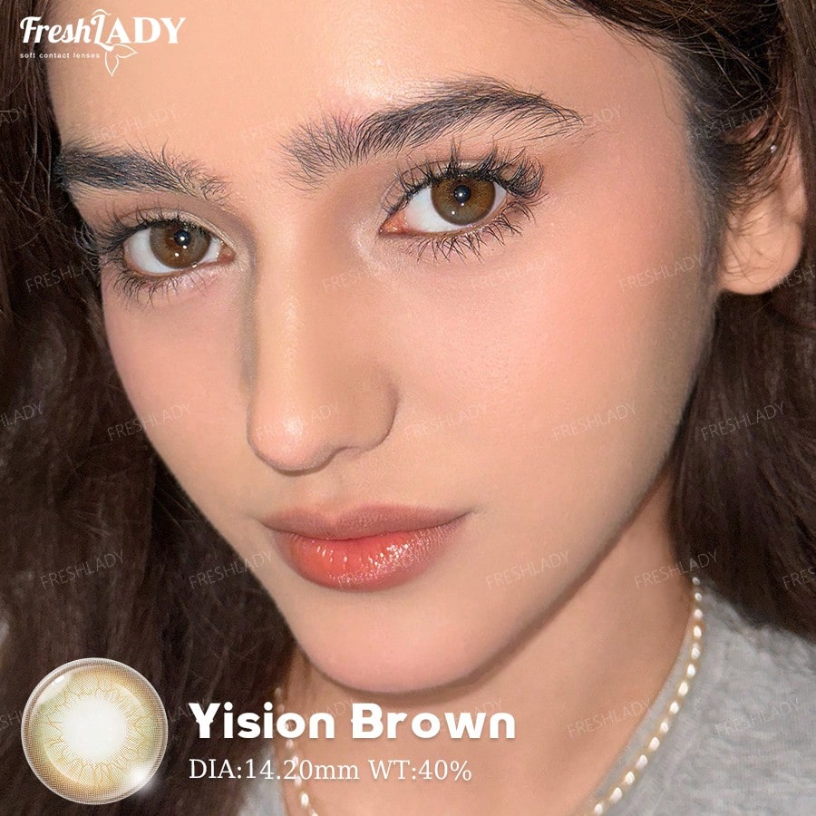 Close-up of a person with brown eyes wearing Vision Brown contact lenses, featuring FreshLADY branding.