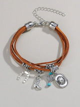 Bracelet with leather straps and various charms on a light gray background