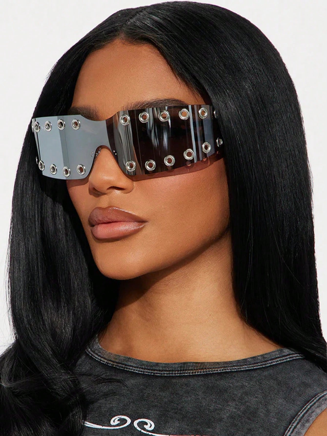 Person wearing futuristic sunglasses with a plain background