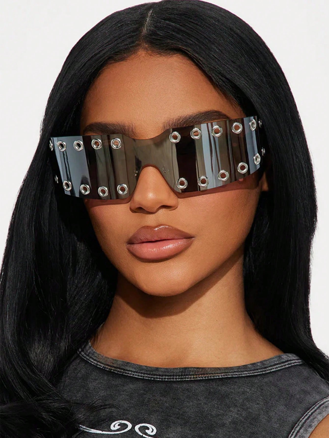 Person wearing futuristic sunglasses with a plain background