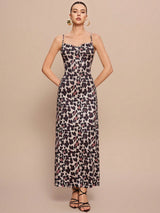 Woman wearing a leopard print dress against a beige background