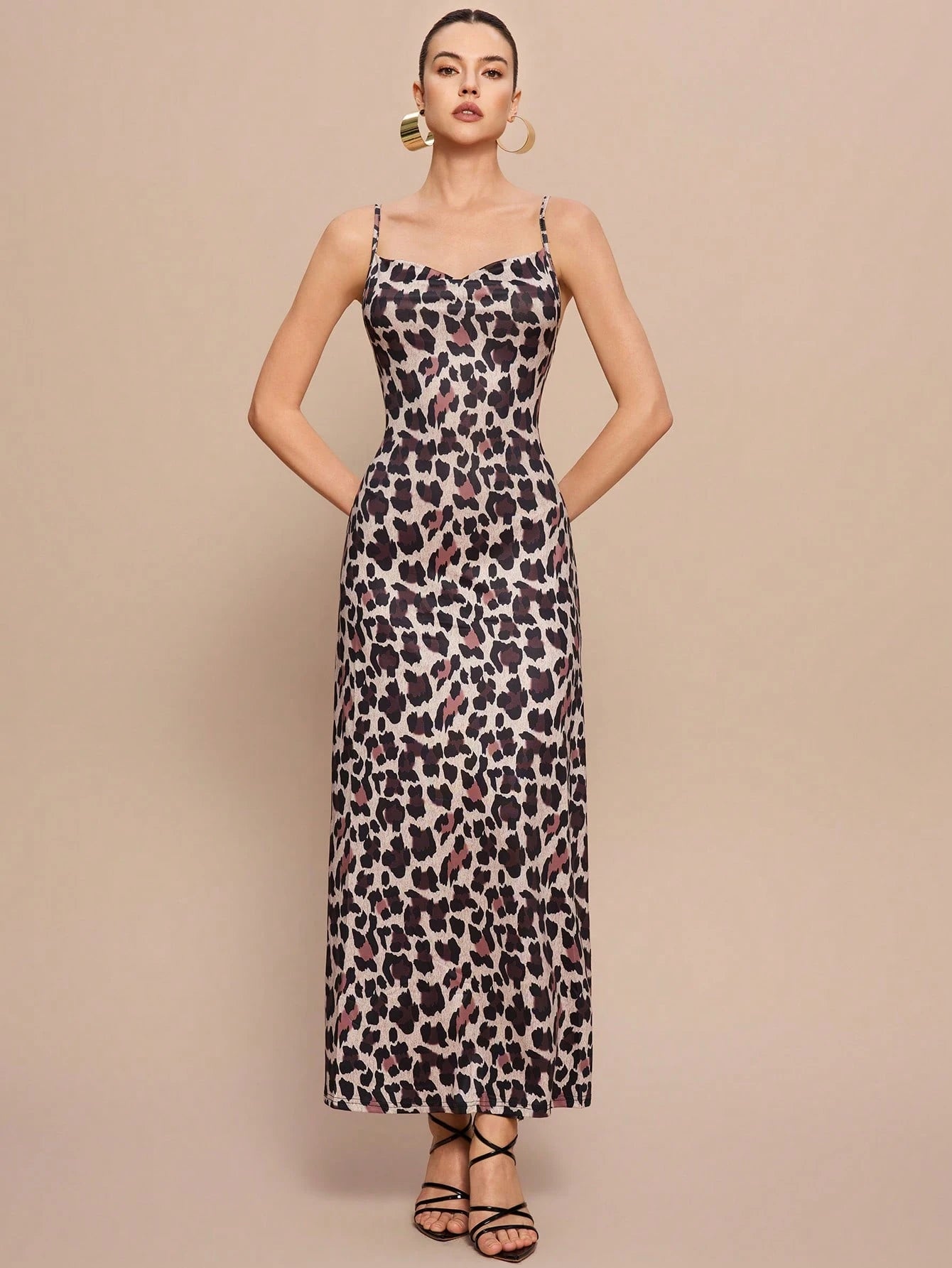 Woman wearing a leopard print dress against a beige background