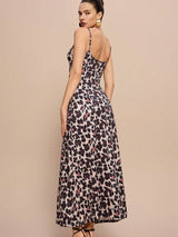 Woman wearing a leopard print dress on a beige background