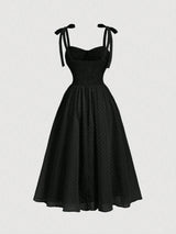 Black dress with bow straps on a white background