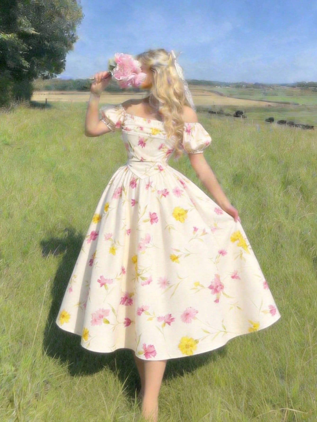 Woman in a floral dress standing in a field with a scenic background