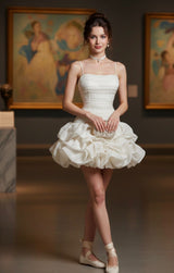 Woman in a white dress standing in an art gallery