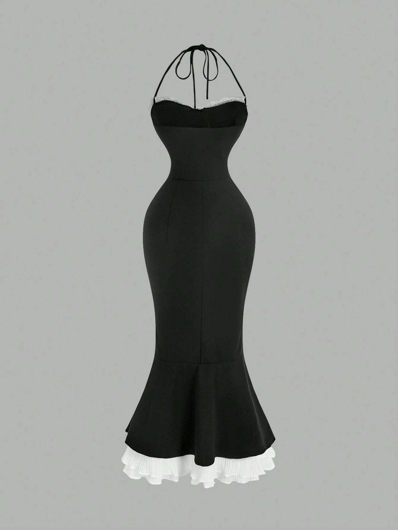 Black dress with ruffled hem on a gray background