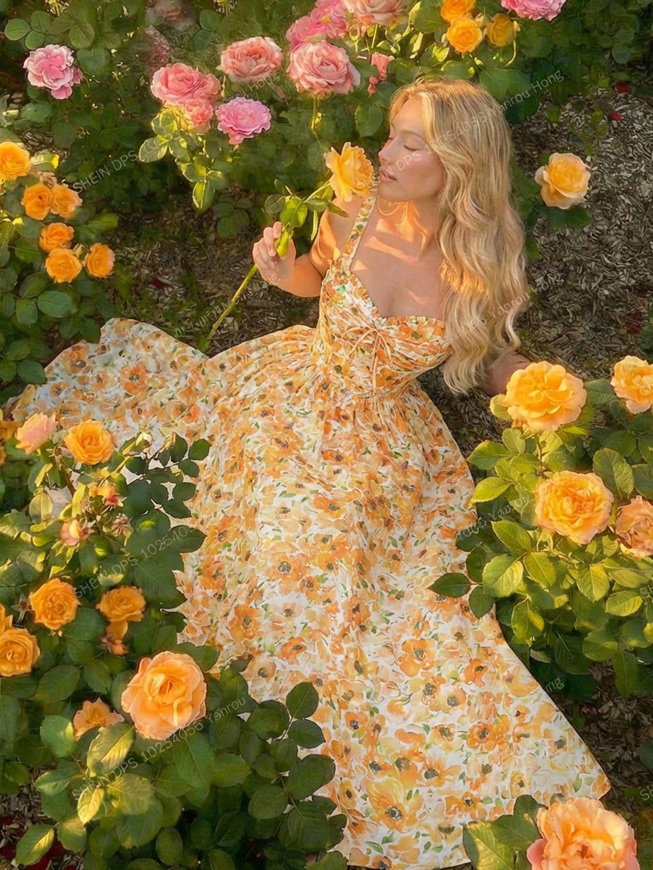 Woman in a floral dress surrounded by flowers in a garden