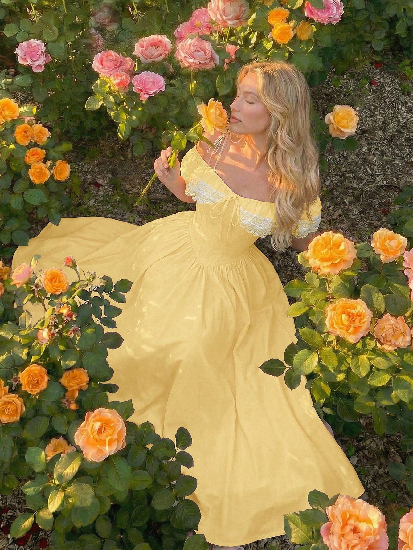Woman in a yellow dress surrounded by flowers in a garden