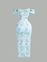 Light blue floral dress with bow straps on a gray background