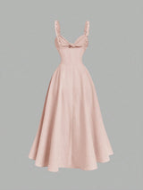 Pink dress with a bow detail on a gray background