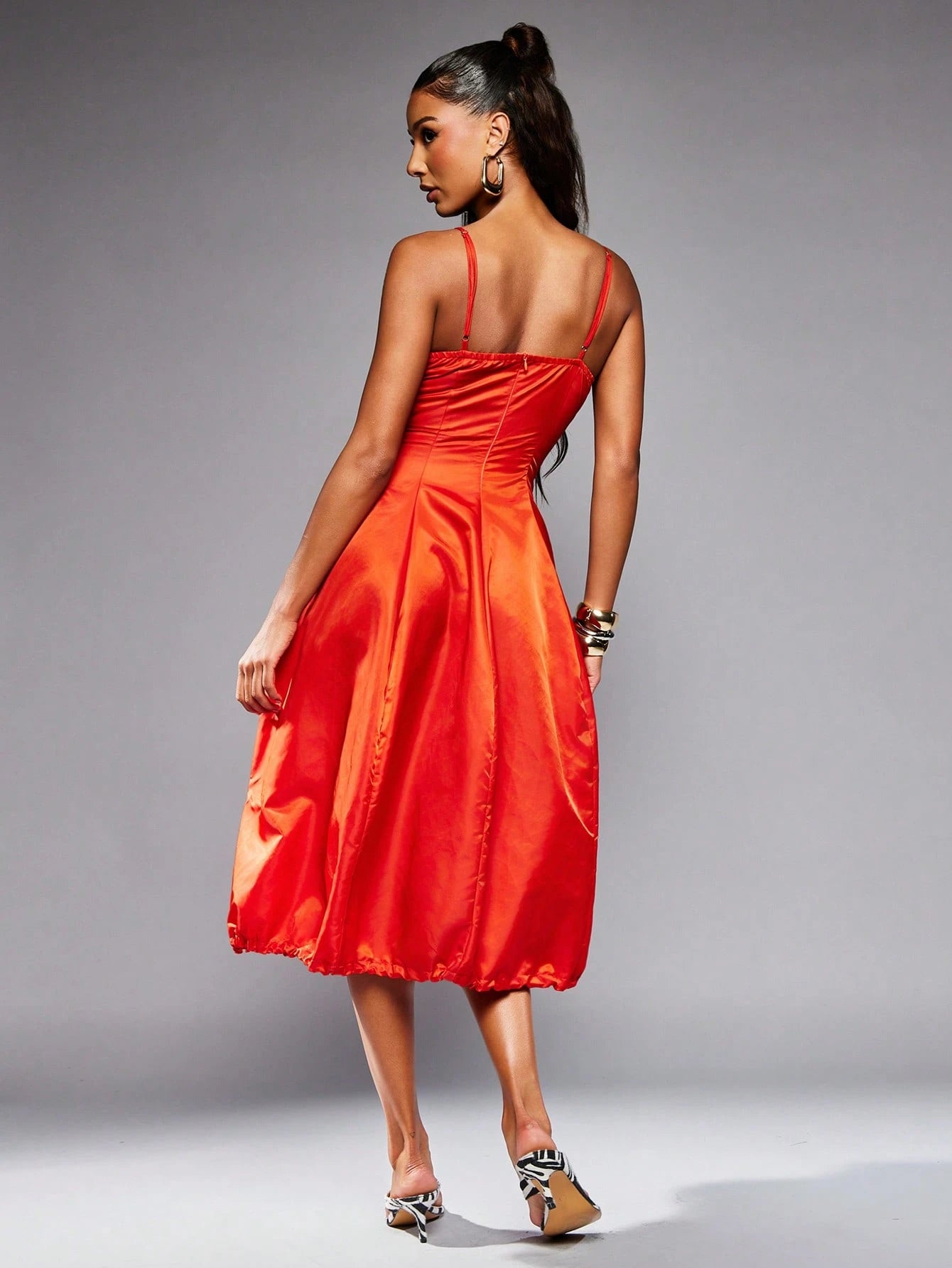 Woman wearing a red dress against a gray background