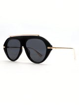 Black sunglasses with gold frame on a white background