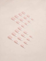 A set of false press-on nails with a pale pink nude base and white French tips, arranged in two rows on a light beige background.