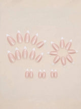 A set of false press-on nails arranged on a light beige background. The nails have a glossy pale pink body with a white French tip.