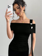 Woman in a black off-shoulder dress with a white background