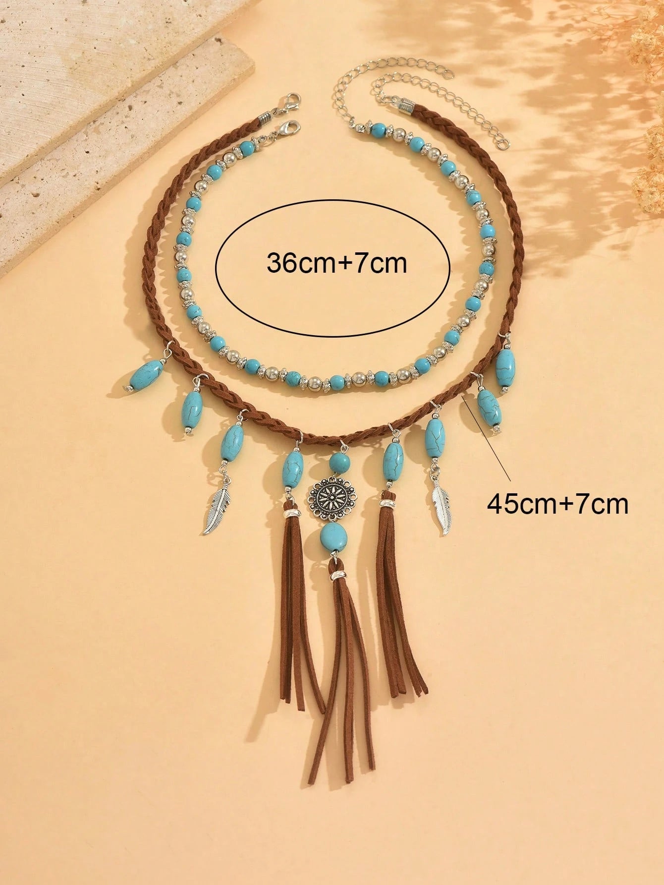 Necklace with turquoise beads and tassels on a beige background