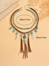 Necklace with turquoise beads and tassels on a beige background