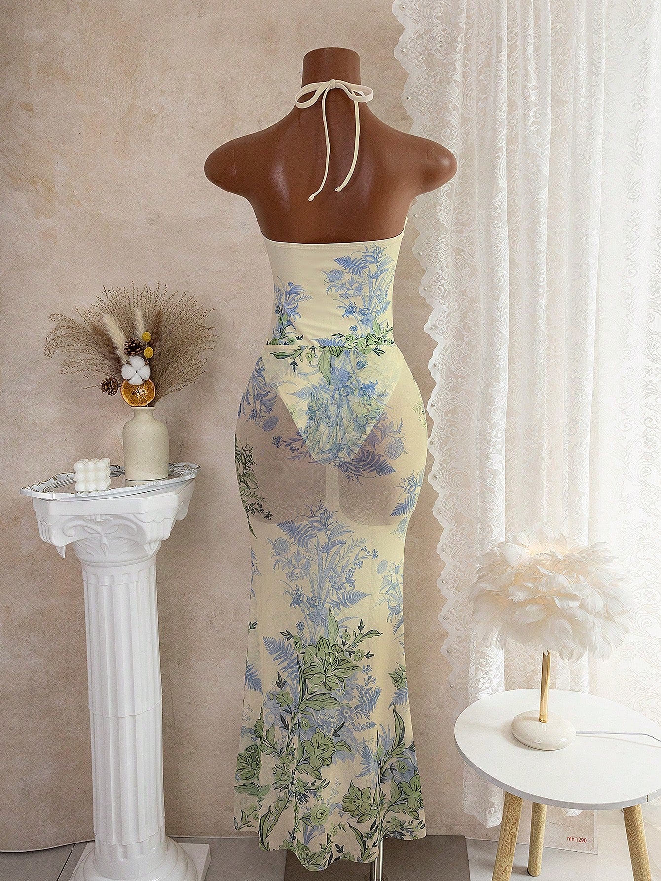 Floral dress on a mannequin against a neutral background