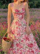 Woman in a floral dress standing in a field of flowers