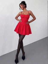 Woman wearing a red dress with a plain background