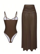 Brown swimsuit with white trim and a matching brown skirt on a white background