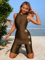Woman in a brown swimsuit with starfish designs on a beach