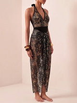 Woman wearing a black and gold lace dress on a white background