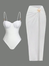 White swimsuit with a starfish detail and white skirt on a gray background