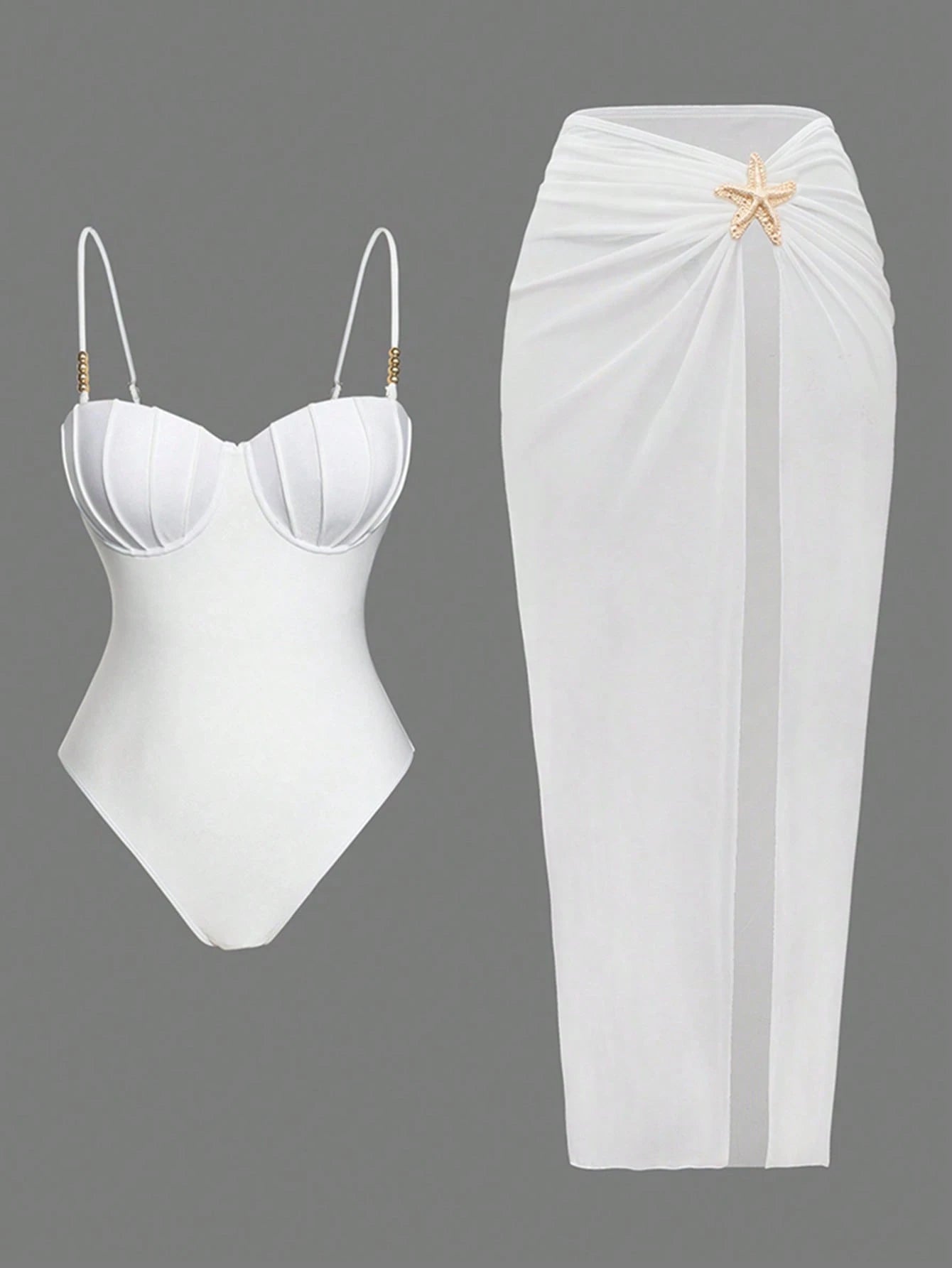 White swimsuit with a starfish detail and white skirt on a gray background