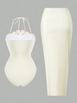 White dress form with floral arrangement on a gray background