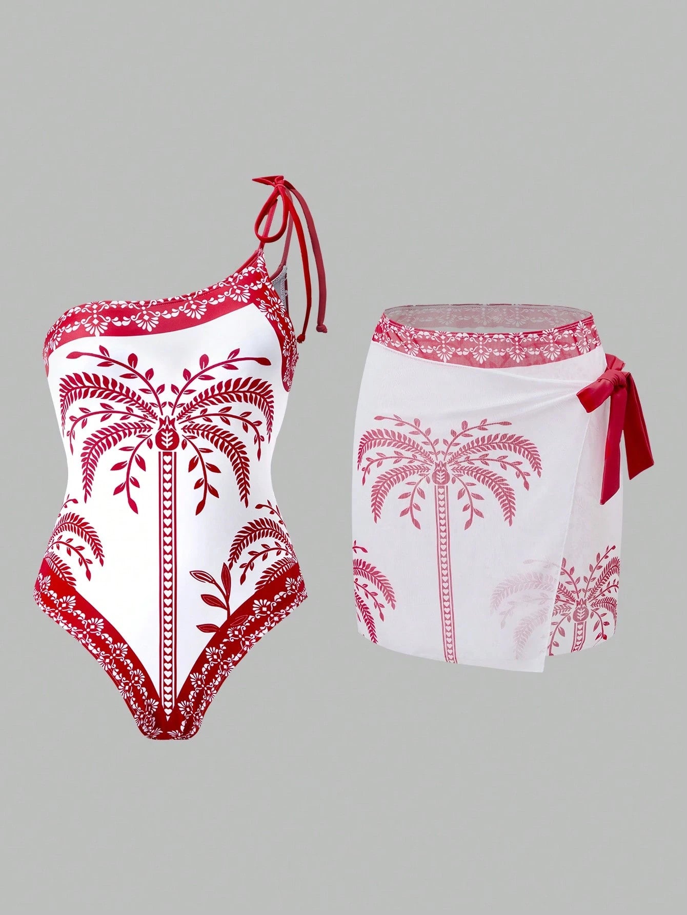 Red and white palm tree patterned swimsuit on a gray background