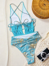 Blue bikini set with gold accents on a textured surface
