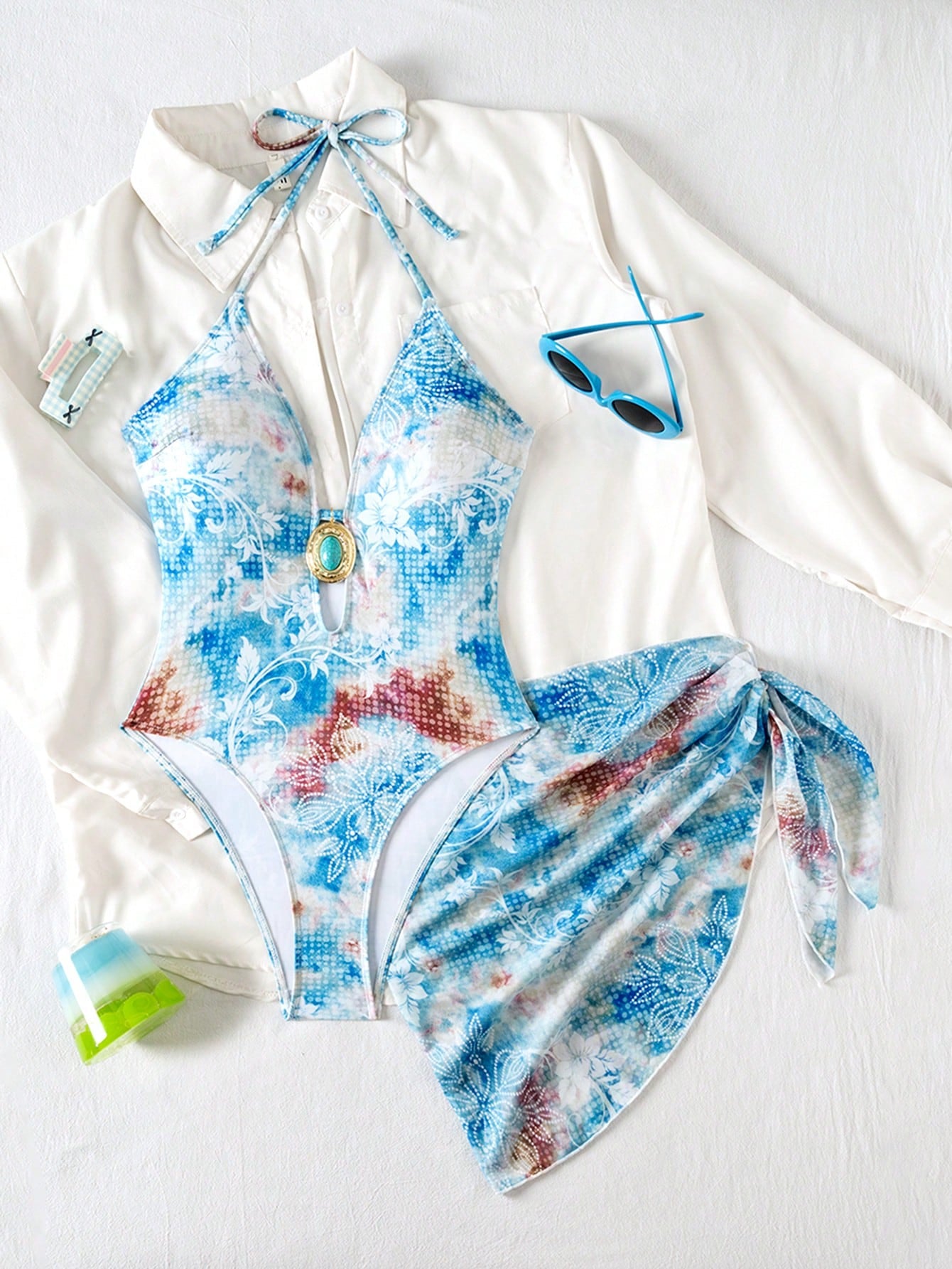 Multicolored swimsuit with a white cover-up on a white background