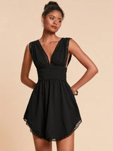 Woman wearing a black dress with lace details on a beige background